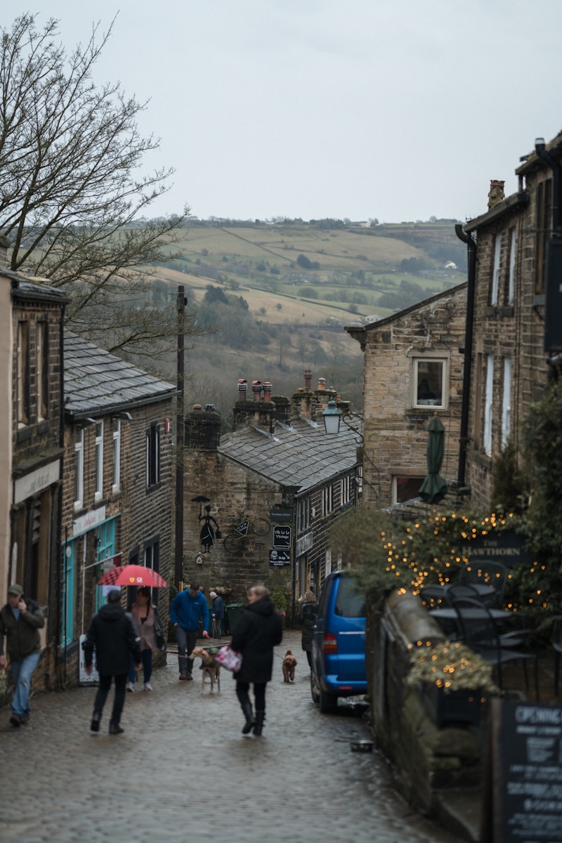 a group of people walking down a cobblestone street